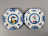 two blue and white plates with pictures of people on them
