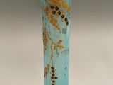 a close up of a blue glass vase on a white surface