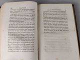 an open book on a table that has a picture of a cat on it