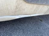 a close up of a car ' s bumper with a dirty paint job