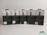 four boxes of black and white packaging on a white surface
