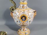 a vase with a snake on it next to a vase