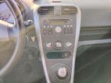 a dashboard of a car with a clock and a steering wheel