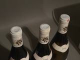 three bottles of wine that are sitting on a table