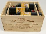 bottles of wine in a wooden box on a white surface