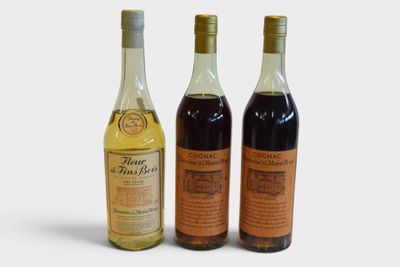 three bottles of wine sitting next to each other on a white surface