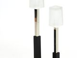 pair of black table lamps with white shades on a white background