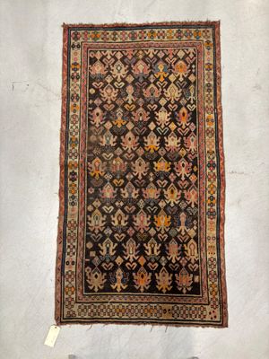 an old rug is displayed on a white surface