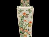 a vase with a painting on it sitting on a stand