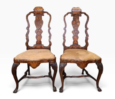 a pair of antique chairs with carved back and upholstered seats