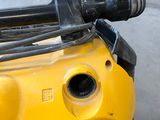 a close up of a yellow machine with a black handle