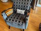 a chair that has a pillow on it in a living room