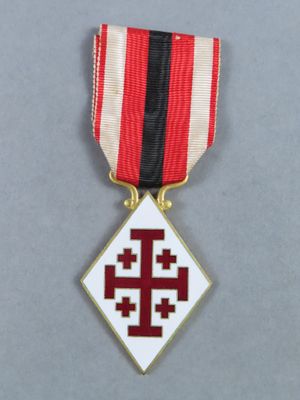 a close up of a medal with a cross on it