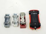 three toy cars are lined up next to each other on a white surface