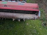 a red lawn mower that is sitting in the grass