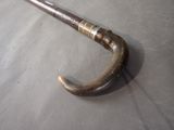 a metal umbrella with a wooden handle on a table
