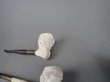 two pipe heads and a pipe holder on a table