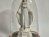 a statue of the virgin mary under a glass dome