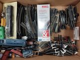 a box full of toy train tracks and other toy trains