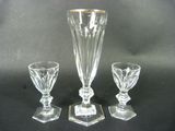three pieces of glass sitting on a black surface