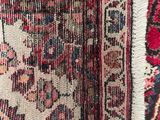 a close up of a rug with a red and blue design