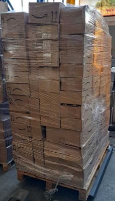 a large stack of boxes on a pallet in a warehouse