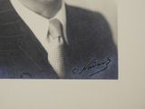 a black and white photo of a man in a suit and tie