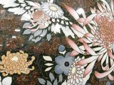a vase with a bird and flowers painted on it