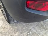 a close up of a car ' s tail light on the side of the road