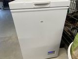 an image of a small white refrigerator in a garage