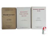three books are sitting on a white surface next to each other