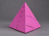 a pink paper pyramid shaped like a watermelon on a gray background