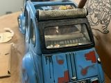 a blue toy car with a bird on top of it