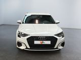 the front view of a white audi car parked in a showroom