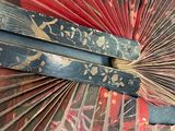 a close up view of a red and black fan