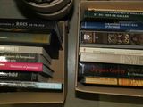 many books that are in a box on the table