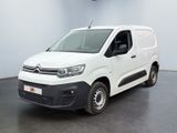 the white van is parked in a large room with a black floor