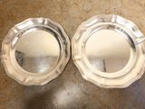 pair of silverplated dishes on a marble counter top