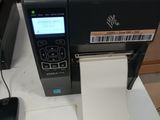 a computer and a printer on a table with a notepad
