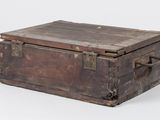 an old wooden box that is sitting on a white surface