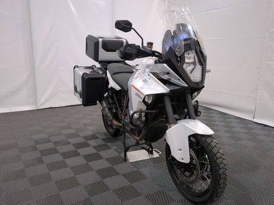 a motorcycle that is parked in a room with a checkered floor