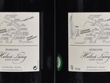 three bottles of wine are lined up on a shelf