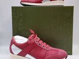 a pair of red and white sneakers sitting on top of a box