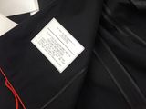 an image of a black jacket with a label on it