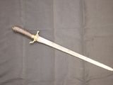 a picture of a knife that is laying on a table