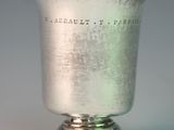 a silver cup that is sitting on a table