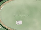 a green vase with a label on it