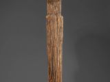 a tall wooden pole with a carved head on top of it