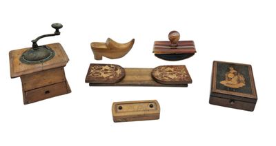 a collection of small wooden objects on display on a white surface