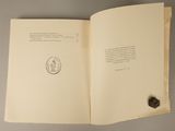 an open book with a stamp on it sitting on a table